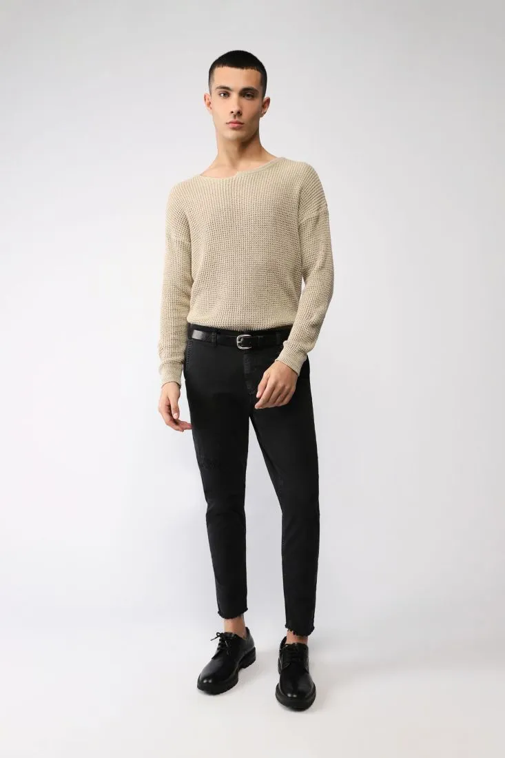 Pantaloni slim-fit con abrasioni e orli al vivo